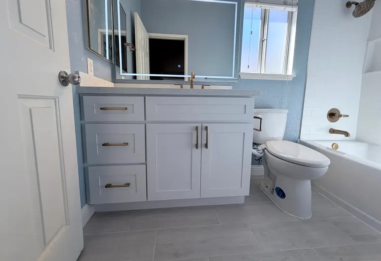 Finished bathroom toilet installation with vanity and tub for a San Jacinto area plumbing customer