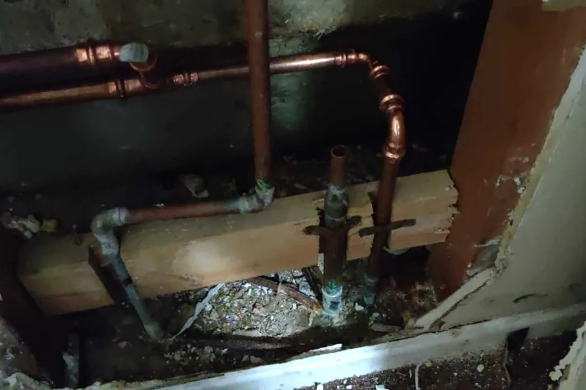 Exposed copper pipe inside opened wall during Lake Elsinore repipe documentation