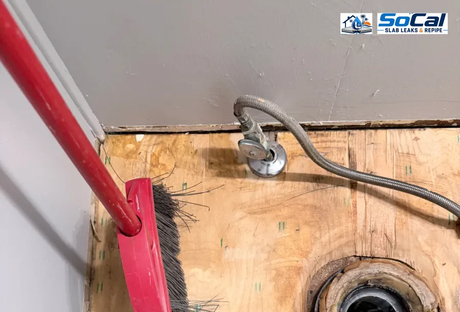 Toilet flange repair close-up for toilet leak and floor-area documentation